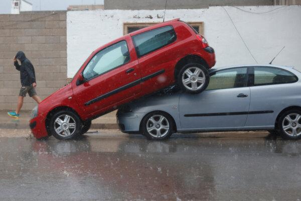 A car sits partially on top of another after heavy rainfall hit Llombai in Valencia, Spain, on Oct. 29, 2024. (Eva Manez/Reuters)
