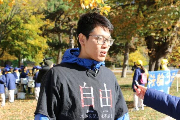 Yi Boyang gives an interview during a rally at Queen's Park in Toronto on Nov. 2, 2024. (The Epoch Times)