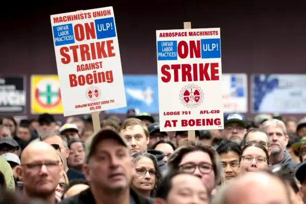 People hold signs during a strike rally for the International Association of Machinists and Aerospace Workers at the Seattle Union Hall in Seattle on Oct. 15, 2024. (Jason Redmond/AFP via Getty Images)