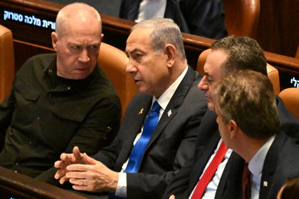 Israeli Prime Minister Benjamin Netanyahu, (C), speaks to Defense Minister Yoav Gallant, (L)— who he fired on Nov. 5, 2024—in the Knesset in Jerusalem, Israel on Oct. 28, 2024. (Debbie Hill/Pool Photo via AP)