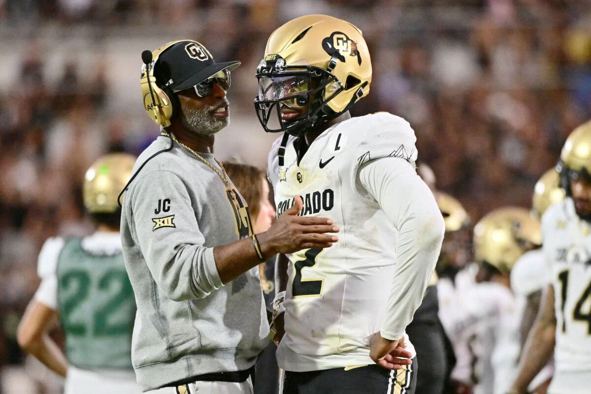 Head coach Deion Sanders of the Colorado Buffaloes talks with Shedeur Sanders (2) during the second half of a game against the UCF Knights at FBC Mortgage Stadium in Orlando, Fla., on Sept. 28, 2024. (Julio Aguilar/Getty Images)