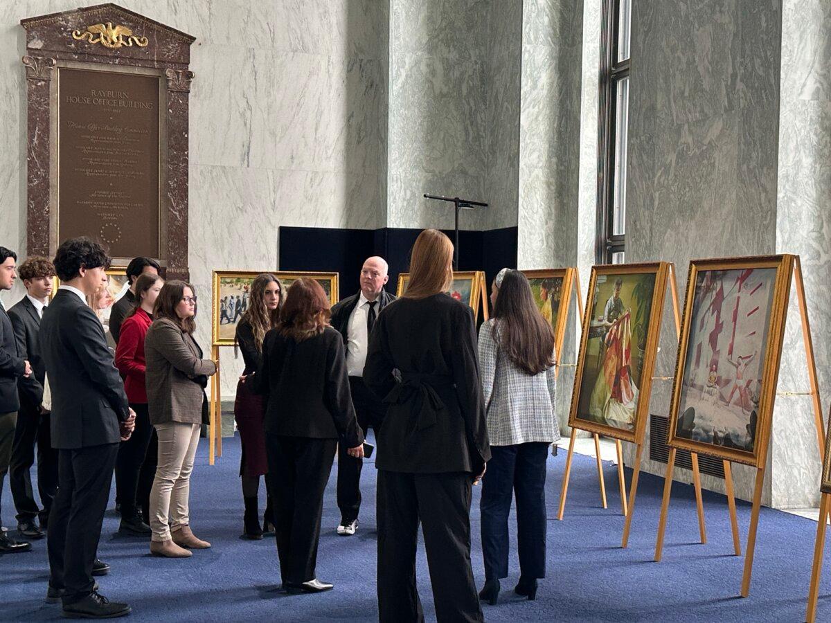 Visitors at the Art of Zhen, Shan, Ren (Truth, Compassion, Tolerance) International Exhibition at the foyer of the Rayburn House Building in Capitol Hill, Washington, on Nov. 13, 2024. (Jenny Jing/The Epoch Times)
