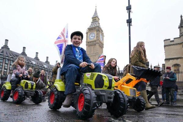 Children on toy tractors during a farmers' protest against inheritance tax in London, on Nov. 19, 2024. (Gareth Fuller/PA Wire)