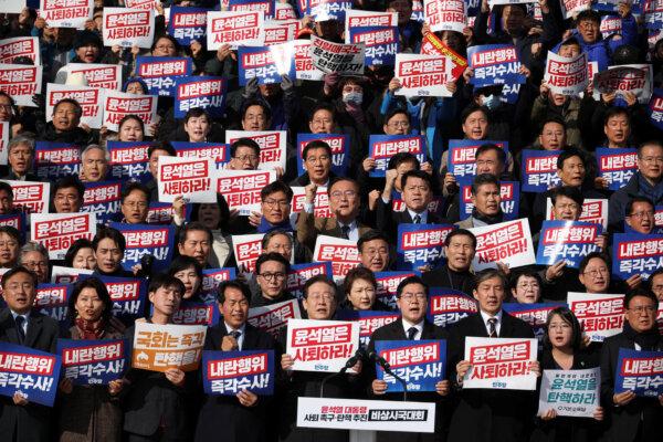 South Korea's main opposition Democratic Party leader, Lee Jae-myung (Center L, at podium) at a rally to condemn the South Korean president’s surprise declarations of martial law in Seoul, South Korea, on Dec. 4, 2024. (Kim Hong-Ji/Reuters)