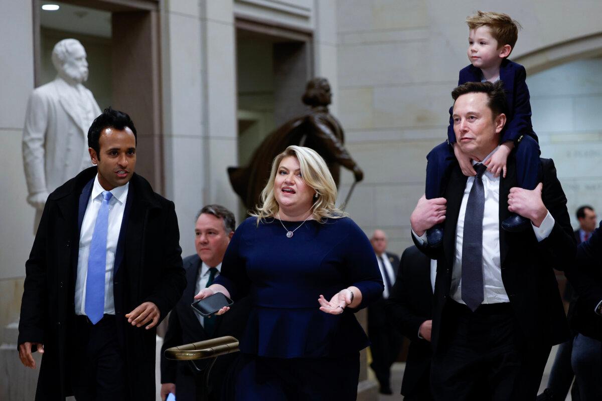 Tesla CEO Elon Musk (R), co-chair of the newly announced Department of Government Efficiency (DOGE), carries his son on his shoulders at the U.S. Capitol following a meeting with businessman Vivek Ramaswamy (L), co-chair of the newly announced Department of Government Efficiency, Rep. Kat Cammack (C), and other members of the U.S. Congress in Washington on Dec. 5, 2024. (Anna Moneymaker/Getty Images)