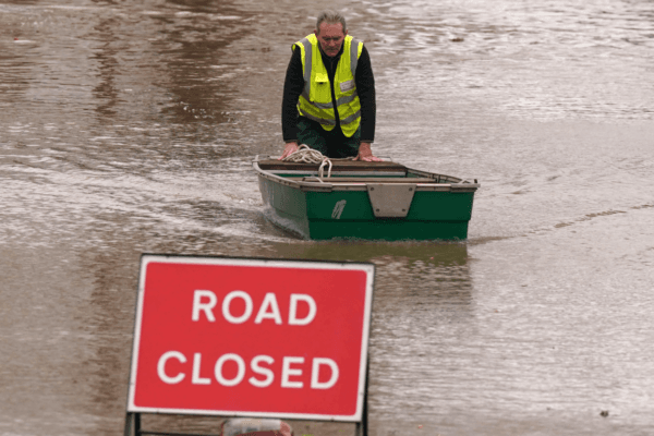 A flood warden pushes a boat in floodwater after Storm Darragh hit the UK and Ireland in Greyfriars Avenue in Hereford, Herefordshire, England, on Dec. 8, 2024. (Jacob King/PA Wire)