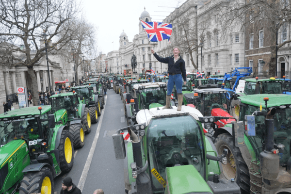 Farmer's daughter Millie Goodwin, 18, whose father runs SW Attwoods and Partners on the Isle of Sheppey, Kent, stands on a tractor parked on Whitehall during a protest by farmers in Westminster, London, on Dec. 11, 2024. (Yui Mok/PA Wire)