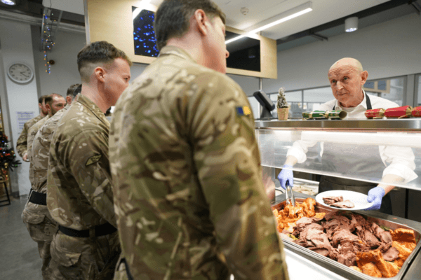 Defence Secretary John Healey serving Christmas lunch to British personnel during his visit to the Tapa military base in Estonia on Dec. 19, 2024. (Stefan Rousseau/PA Wire)