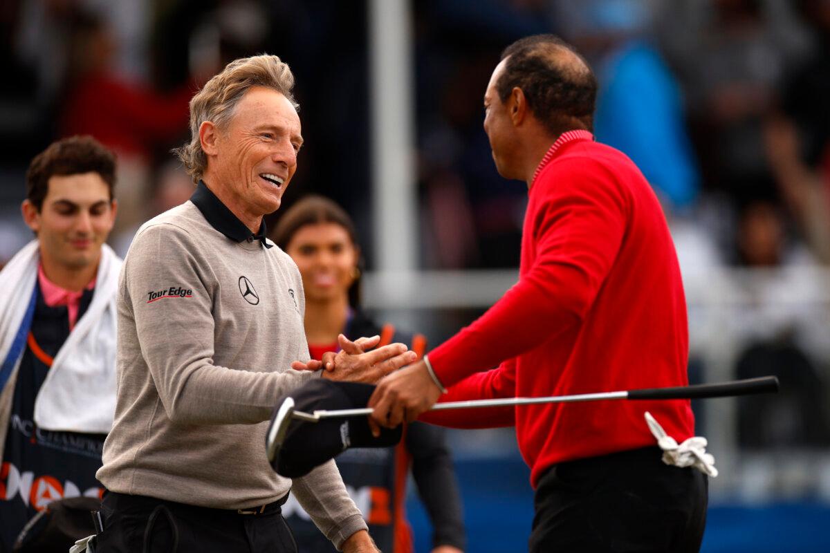 Tiger Woods (R) of the United States reacts with Bernhard Langer of Germany after their round on the 18th green during a sudden-death playoff during the second round of the PNC Championship at Ritz-Carlton Golf Club in Orlando, Fla., on Dec. 22, 2024. (Mike Ehrmann/Getty Images)