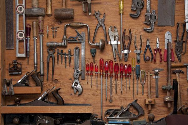 Garden tools can be easily organized by hanging them on the wall. (Daleen Loest/Shutterstock)