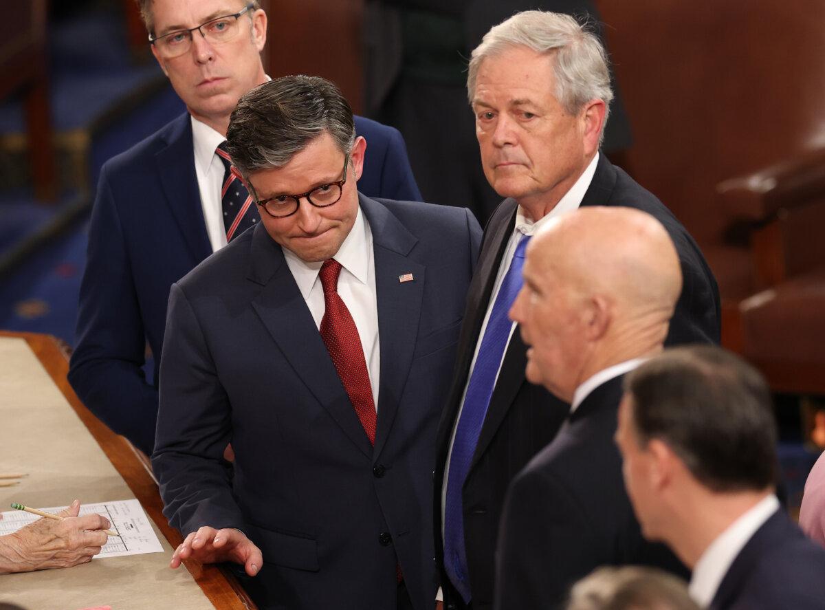 Rep. Mike Johnson (R-La.) (L) speaks with Reps. Ralph Norman (R-S.C.) (C) and Keith Self (R-Texas) as the House votes for Speaker of the House on the first day of the 119th Congress in the House Chamber of the U.S. Capitol Building on Jan. 3, 2025. (Win McNamee/Getty Images)