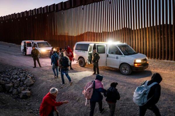 Migrants turn themselves in to U.S. Customs and Border Patrol officers after crossing over a section of border wall into the U.S. in Ruby, Ariz., on Jan. 5, 2025. (Brandon Bell/Getty Images)