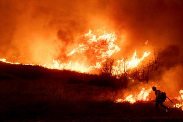 A firefighter sets a 'backburn' in front of the advancing Kenneth Fire in the West Hills section of Los Angeles on Jan. 9, 2025. (Ethan Swope/AP Photo)
