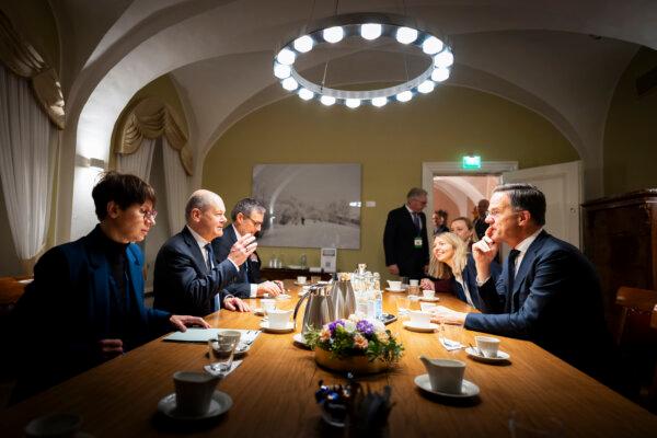 Chancellor of Germany Olaf Scholz (2ndL) talks with Mark Rutte (R), Secretary General of NATO, along with his office manager Jeanette Schwamberger (L) and his adviser on foreign and security policy Jens Plötner (3rdL) during the Baltic Sea NATO Allies Summit in Helsinki, Finland, on Jan. 14, 2025. (Steffen Kugler/Bundesregierung via Getty Images)