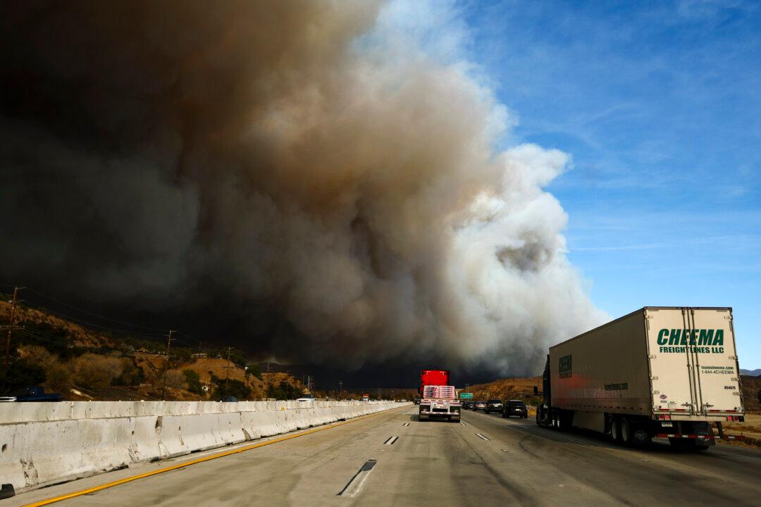 Day in Photos: New Fires Near Los Angeles, Knife Attack in France, and Camel Racing