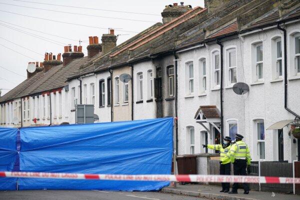 Police at the scene in Collingwood Road, Sutton, south London, where the two sets of twin boys died in a house fire on Dec. 16, 2021. (Yui Mok/PA)