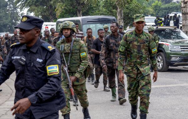 Rwandan security officers escort members of the Armed Forces of the Democratic Republic of the Congo (FARDC), who surrendered in Goma, Congo, following fighting between M23 rebels and the FARDC, in Gisenyi, Rwanda, on Jan. 27, 2025. (Reuters/Jean Bizimana)