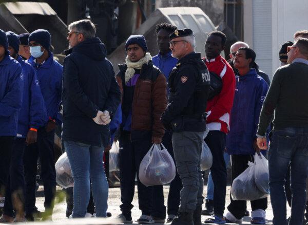 Migrants gather after disembarking from the Italian navy ship Cassiopea in Shengjin, Albania, on Jan. 28, 2025. (REUTERS/Florion Goga)