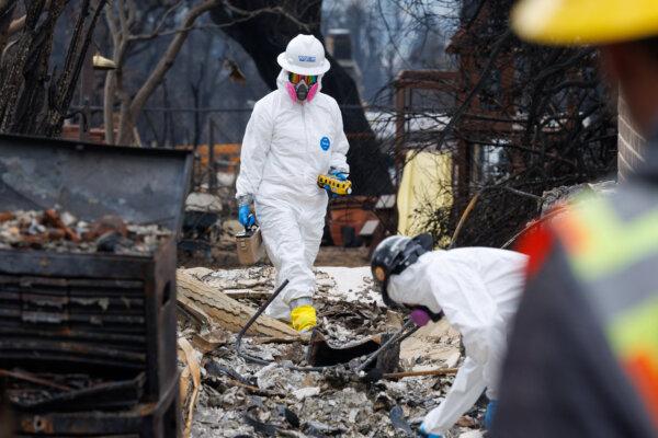 Specialists from the Environmental Protection Agency work to remove toxic and hazardous debris from a burned home following the Eaton Fire in Altadena, Calif., on Jan. 30, 2025. (Mike Blake/Reuters)