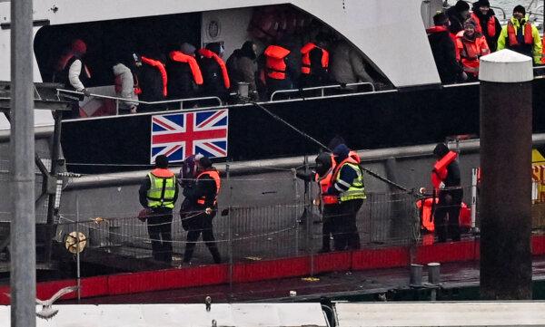 Migrants picked up at sea attempting to cross the English Channel from France disembark from Border Force vessel Typhoon after it arrived at the Marina in Dover, southeast England on Feb. 9, 2025. (Ben Stansall/AFP via Getty Images)