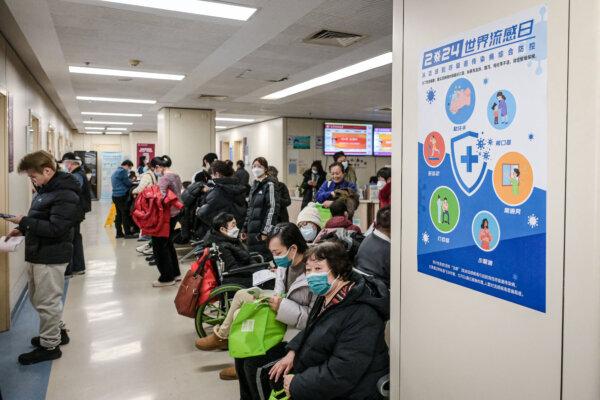 People wearing masks wait at an outpatient area of the respiratory department of a hospital in Beijing on Jan. 8, 2025. (Jade Gao/AFP via Getty Images)