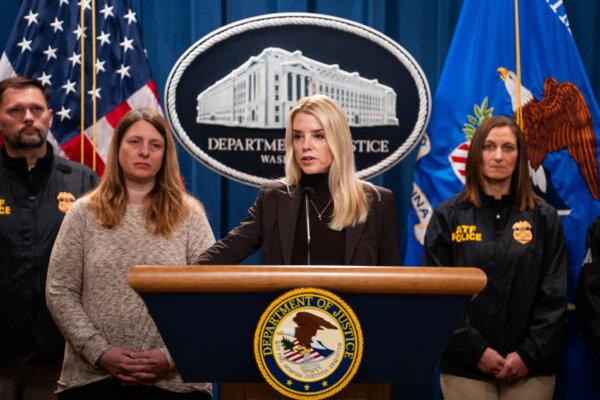 Attorney General Pam Bondi, joined by Tammy Nobles (L), mother of Kayla Hamilton who was killed by an illegal immigrant, speaks during a press briefing at the Department of Justice in Washington on Feb. 12, 2025. (Madalina Vasiliu/The Epoch Times)