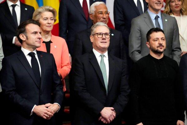 (L–R) France's President Emmanuel Macron, Britain's Prime Minister Sir Keir Starmer, and Ukraine's President Volodymyr Zelenskyy pose for a family photograph during a summit held at Lancaster House in central London on March 2, 2025. (Christophe Ena/Pool/AFP via Getty Images)