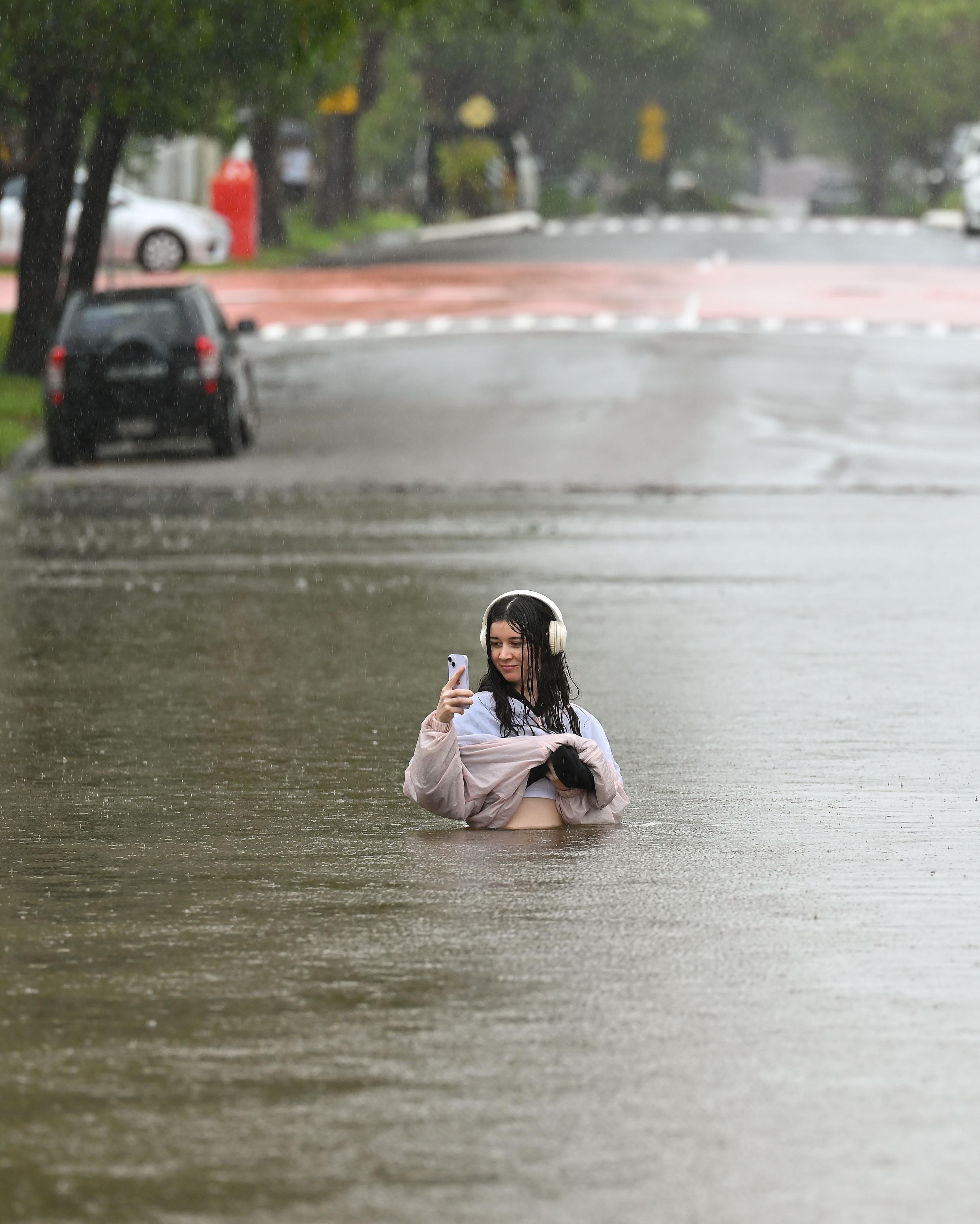 Day in Photos: Flooding in Australia, Confrontation Outside White House, Rally in Syria