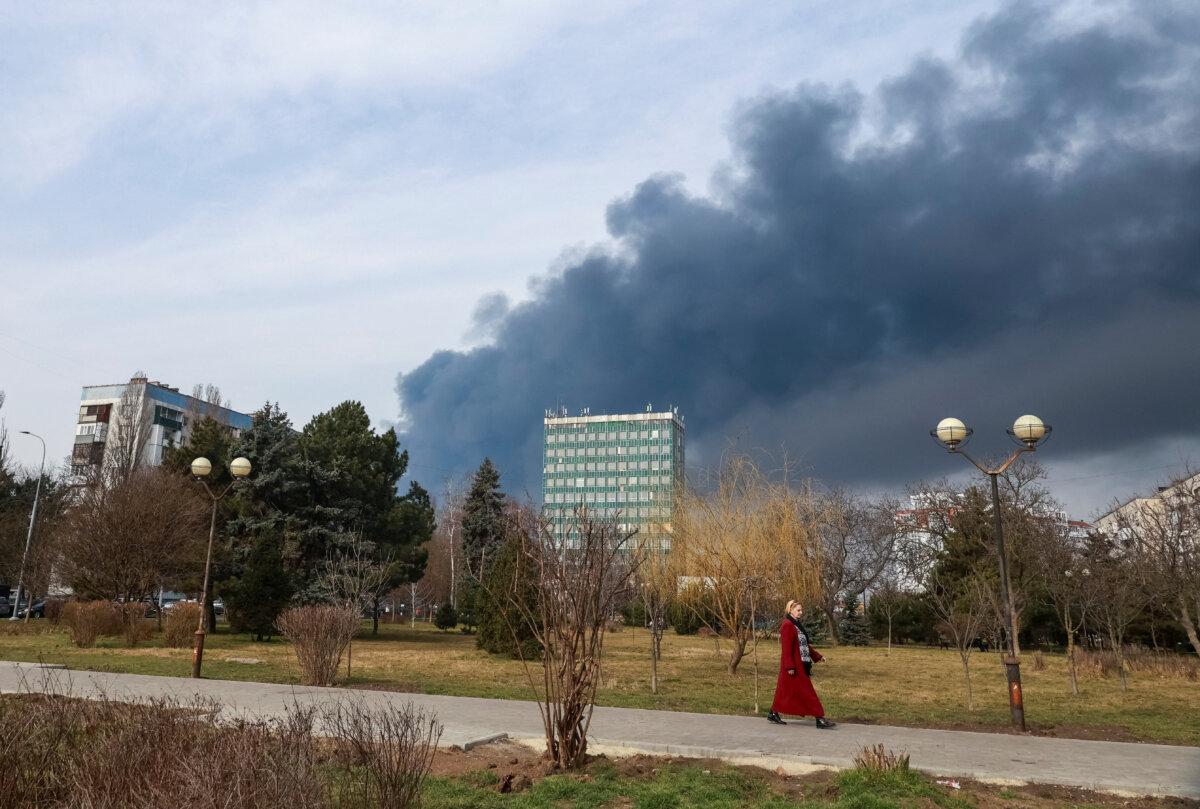 A resident walks, as smoke rises in the sky at the site of a Russian drone strike, amid Russia's attack on Ukraine, in Odesa, Ukraine Mar. 11, 2025. (Nina Liashonok/Reuters)