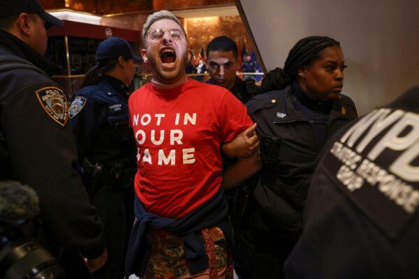 New York Police officers arrest a demonstrator from the group, Jewish Voice for Peace, who protested inside Trump Tower in support of Mahmoud Khalil, in New York, on March 13, 2025. (Yuki Iwamura/AP Photo)