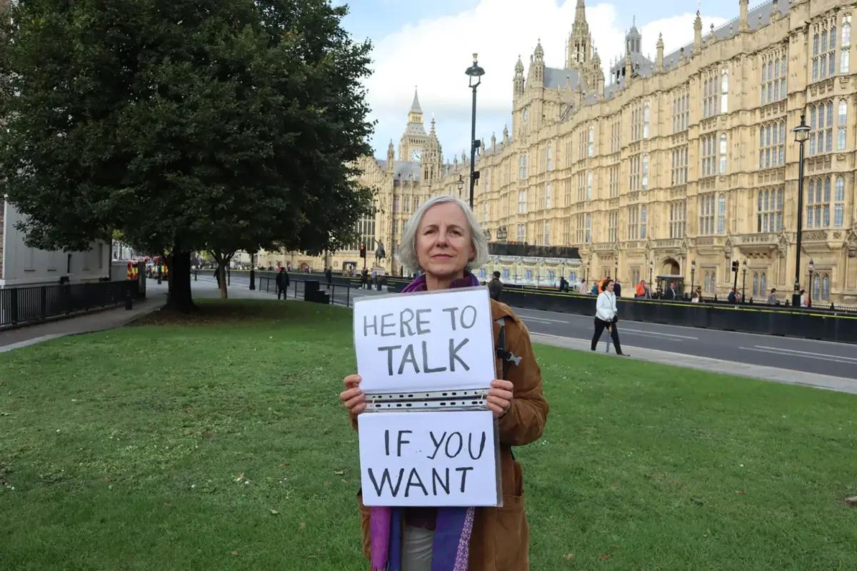 Livia Tossici-Bolt outside the Houses of Parliament with the sign she held within the "buffer zone" of a Bournemouth abortion clinic, in London in an undated handout photo. (Courtesy of ADF)