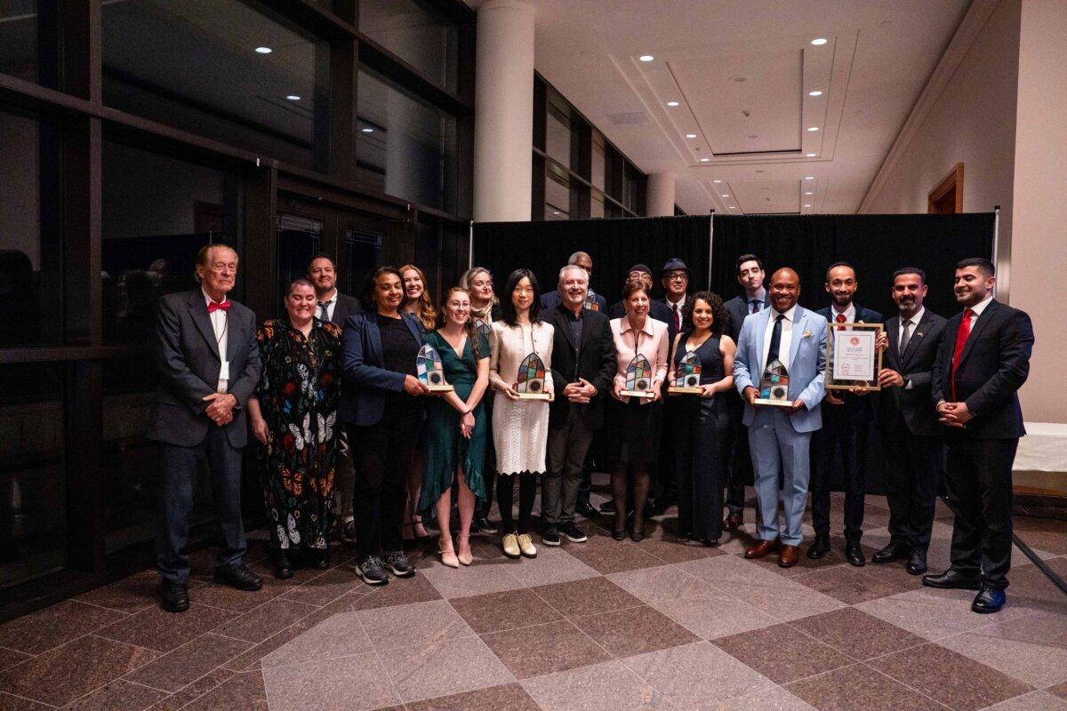 Winners of annual awards given by the Religion Communicators Council—including Epoch Times reporters Eva Fu (8th L) and Dan Berger (7th R)—pose for a photo during the organization’s annual conference in Salt Lake City on April 25, 2025. (Madalina Vasiliu/The Epoch Times)