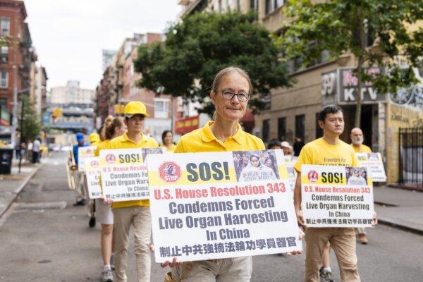 Falun Gong practitioners march during a parade calling for the end of the Chinese Communist Party's 25 years of ongoing persecution against the spiritual practice, in New York City on July 20, 2024. (Samira Bouaou/The Epoch Times)