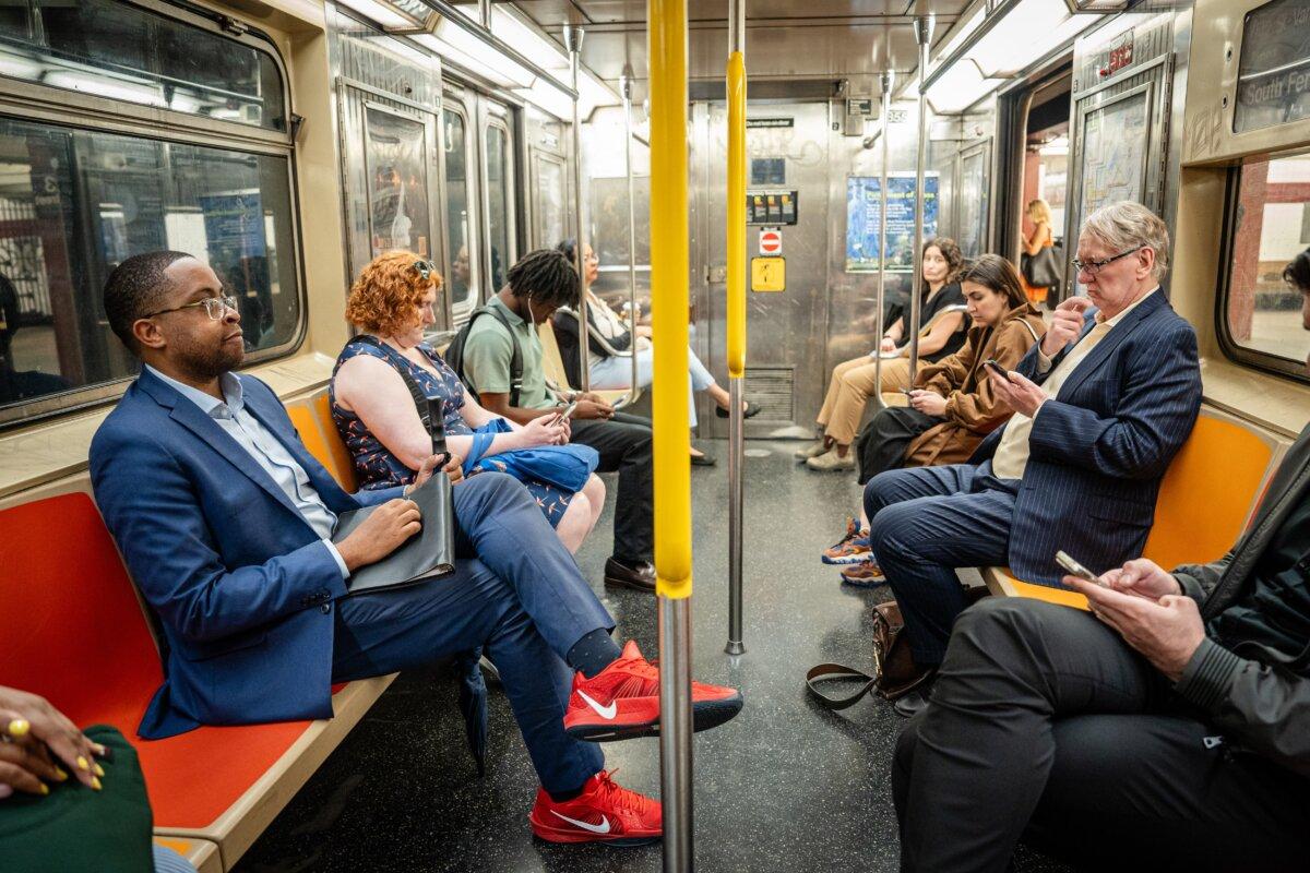 New York state Sen. and New York City mayoral candidate Zellnor Myrie (L) takes the subway in New York City on June 10, 2025. (Samira Bouaou/The Epoch Times)