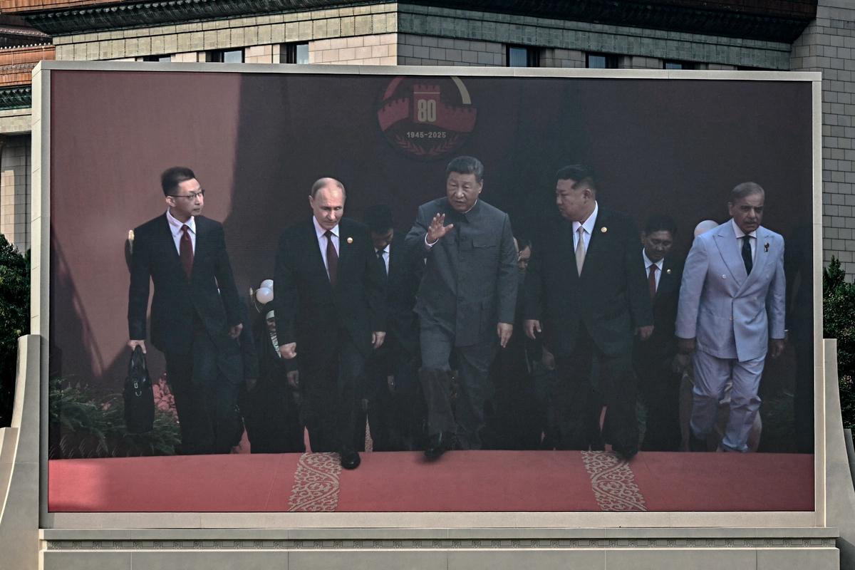 A display shows Chinese leader Xi Jinping (C) walking alongside Russian President Vladimir Putin (center L) and North Korean leader Kim Jong Un (center R) before a military parade marking the 80th anniversary of victory over Japan and the end of World War II, in Tiananmen Square, Beijing, on Sept. 3, 2025. (Pedro Pardo/AFP via Getty Images)