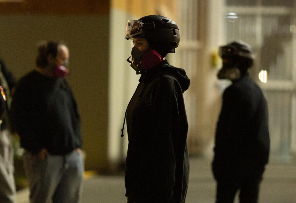 Protesters position themselves in front of Immigration and Customs Enforcement offices in Portland, Ore., on Oct. 5, 2025. (John Fredricks/The Epoch Times)