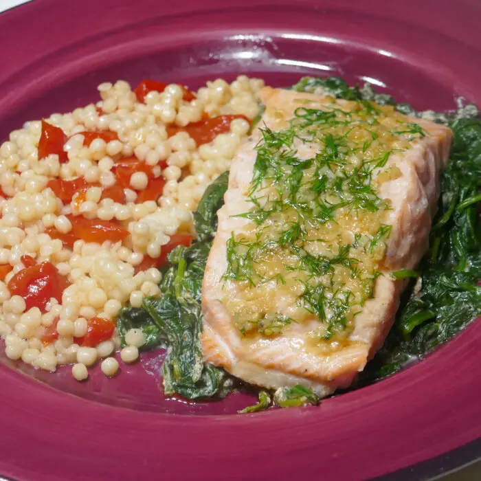Garlic and Herb Salmon on Creamy Spinach With Pimento Couscous