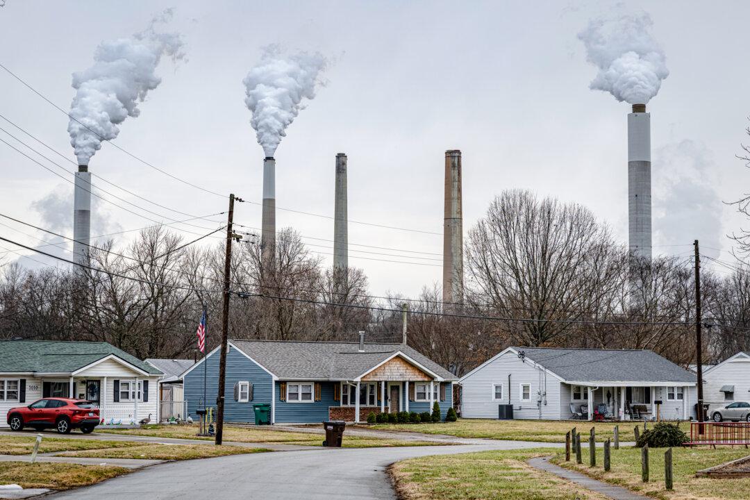 The flue-gas stacks of Mill Creek Generating Station are seen from the Valley Village neighborhood in Louisville, Ky., on Feb. 14, 2026. President Donald Trump recently announced the repeal of an Obama-era rule that imposed greenhouse gas emissions restrictions on US industries. (Jon Cherry/Getty Images)