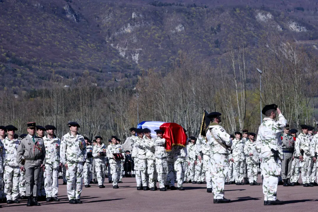 TOPSHOT - French soldiers of "Troupes de montagne" of Chasseurs Alpins (Alpine Hunters) carry the coffin of Chief Warrant Officer Arnaud Frion who was killed in a drone attack in Erbil on March 12, 2026, during a national tribute ceremony at the 7th Alpine Chasseurs Battalion in Varces, southeastern France on March 17, 2026. Arnaud Frion was killed and six other French soldiers were wounded on March 12, 2026 evening in a drone attack in the Erbil region of Iraqi Kurdistan, French authorities announced, lamenting the first death within the French army in the context of the war in the Middle East. (Photo by Alex MARTIN / AFP via Getty Images)