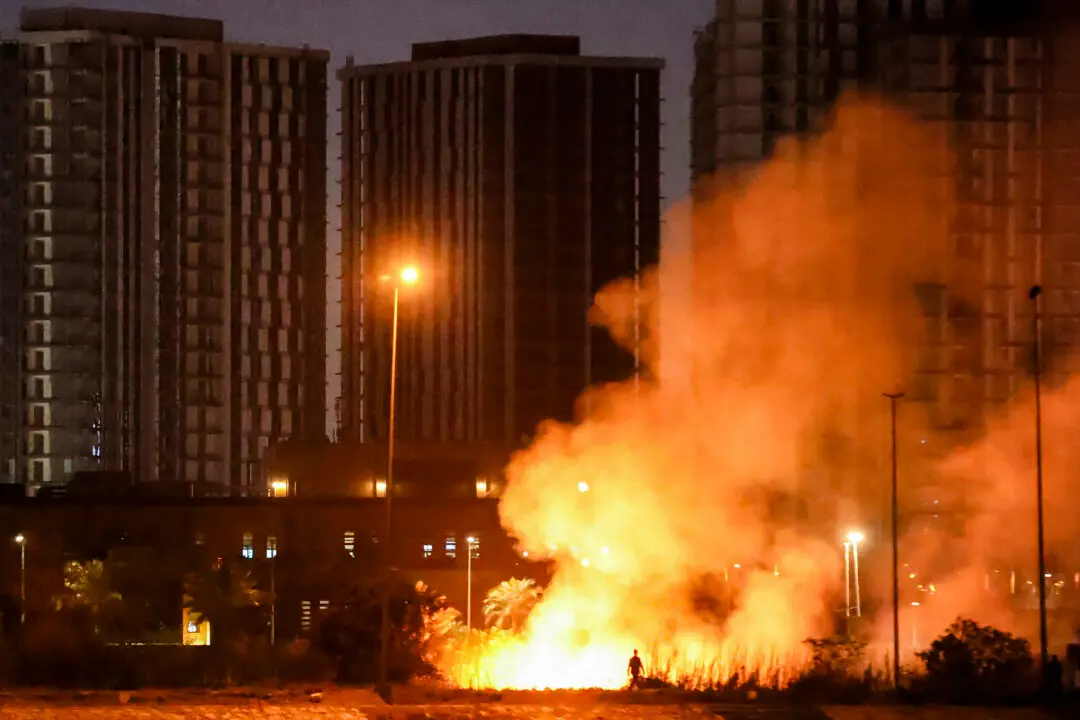 TOPSHOT - A fire burns on the grounds of the US Embassy headquarters in Baghdad's fortified "Green Zone" on March 17, 2026 following a drone and rocket attack according to security officials. The strikes came hours after air defences thwarted a rocket attack at the embassy and a drone sparked a fire at a luxury hotel frequented by foreign diplomats in the Green Zone. Iraq was drawn into the Middle East war after having long been a proxy battleground between the US and Iran, with strikes targeting Iran-backed groups that have claimed daily attacks on US interests in Iraq and across the region. (Photo by AHMAD AL-RUBAYE / AFP via Getty Images) /