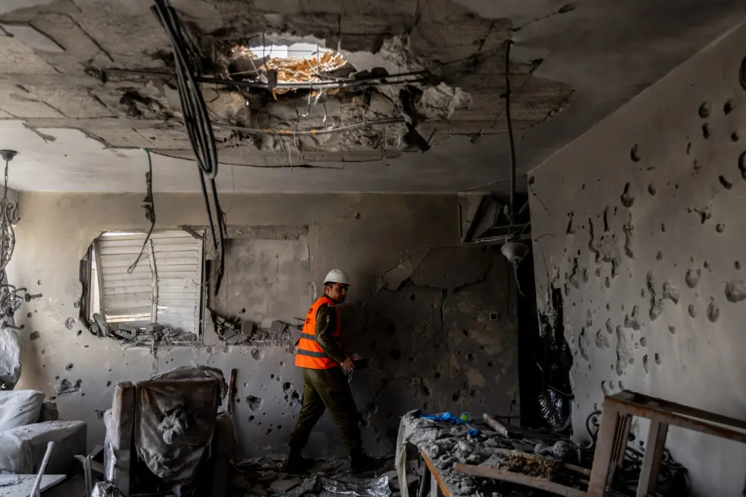 An Israeli emergency responder inspects the impact of an Iranian missile strike at an apartment, leaving an elderly couple dead in Ramat Gan, Israel, on March 18, 2026. (Amir Levy/Getty Images)