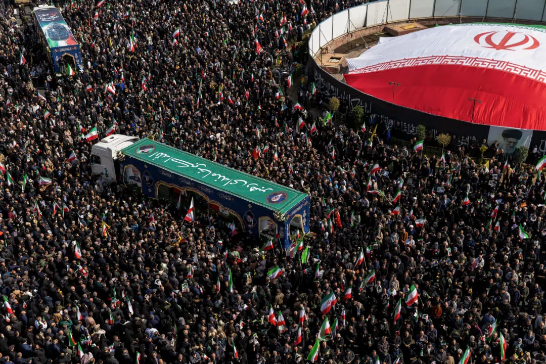Large crowds gather during a joint funeral held for Ali Larijani, Secretary of Iran's Supreme National Security Council, Basij commander Major General Gholam Soleimani, and 84 sailors from the Iranian Navy frigate IRIS Dena, in Tehran, Iran, on March 18, 2026. Larijani and Gholamreza, two of the highest-ranking Iranian officials to be assassinated since the outbreak of the war on February 28, were killed in US-Israeli airstrikes on March 17, according to Iranian state media. The 84 sailors were killed when the IRIS Dena was sunk in a torpedo strike by the USS Charlotte, an American submarine,off the coast of Sri Lanka on March 4. (Majid Saeedi/Getty Images)