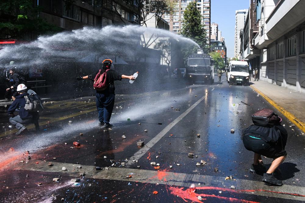 Day in Photos: Swiss Ice Skaters, Protests in South America, and Conflict in the Middle East