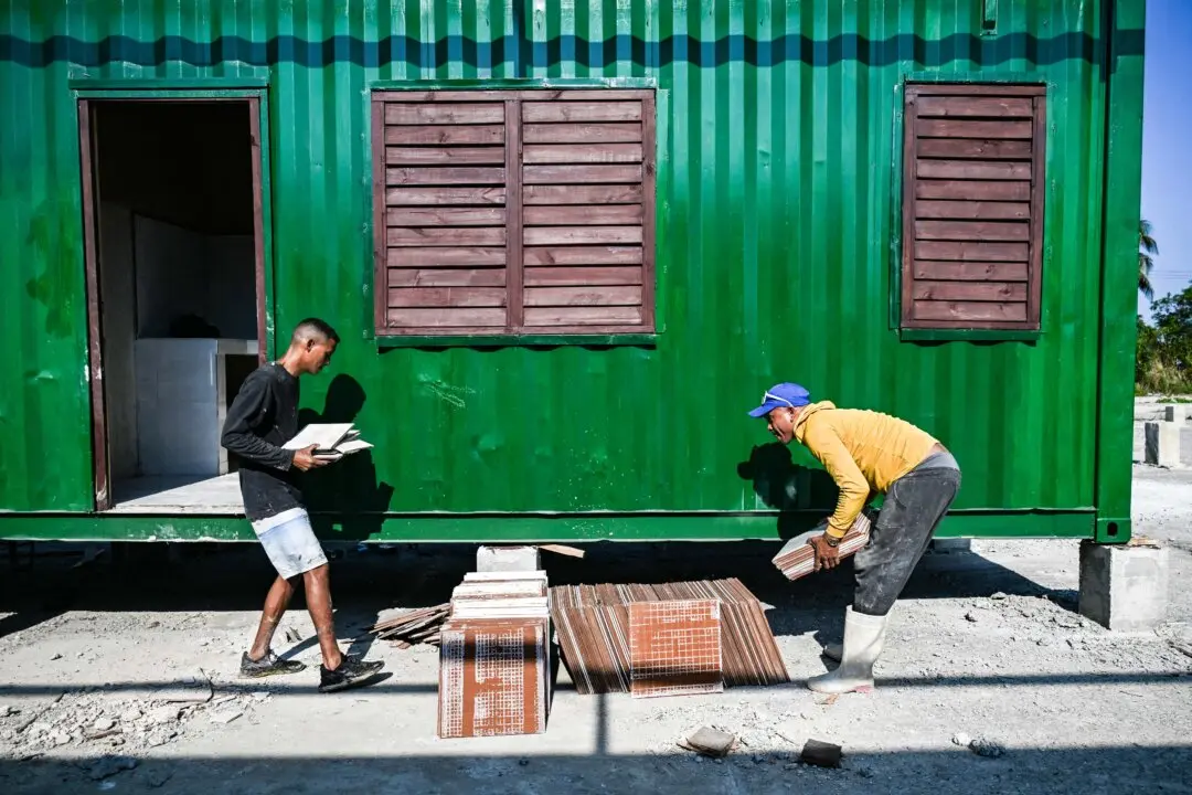Day in Photos: Shipping Containers Housing, Mail Carriers’ Strike, and ISIS-Linked Women Returning to Australia
