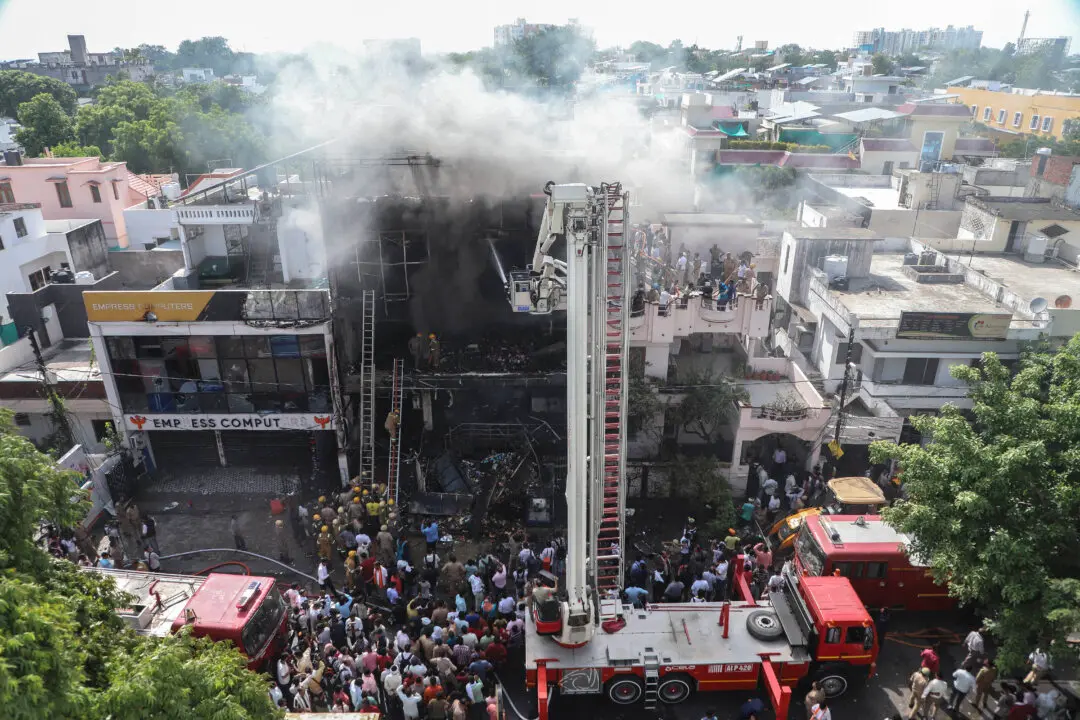 Day in Photos: India Fire Disaster, South Africa Protest Rally, and Ancient Mural Uncovered
