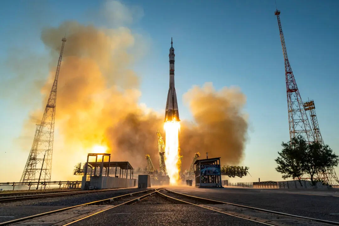 Day in Photos: Soyuz ISS Launch, France Bastille Day Parade, and Van Collision in Chile