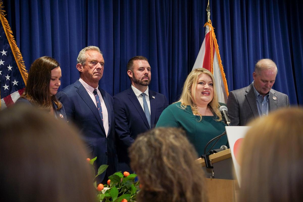 From left, Sen. Ashley Moody (R-Fla.), Health and Human Services Secretary Robert F. Kennedy Jr., acting Food and Drug Administration Commissioner Kyle Diamantas, Rep. Kat Cammack (R-Fla.), and Florida Commissioner of Agriculture Wilton Simpson at a press conference announcing an FDA rule change for pasteurized orange juice sugar content in Lakeland, Fla., on July 17, 2026. (Jacob Burg/The Epoch Times)