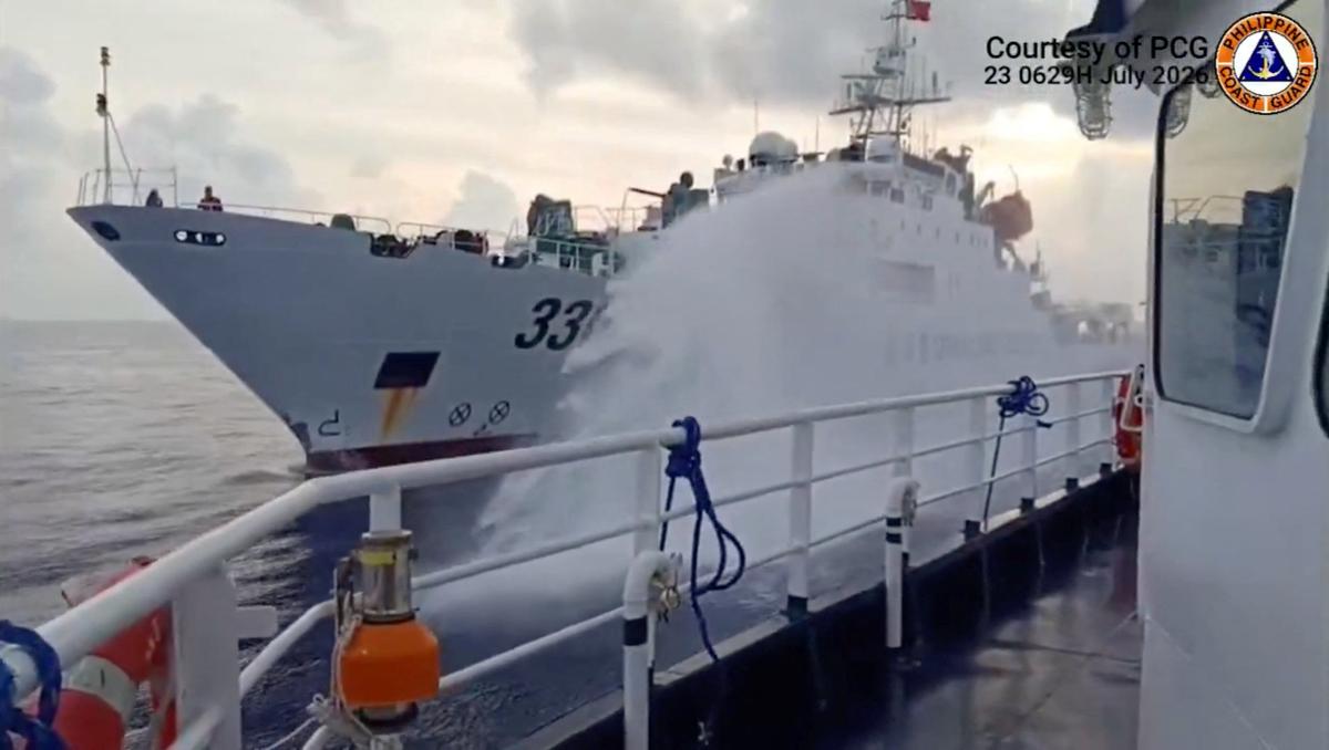 A Chinese coast guard ship fires a water cannon at a Philippine vessel in the South China Sea, in this screengrab taken from a handout video released on July 23, 2026. (Jay Tarriela via X/Handout via Reuters)
