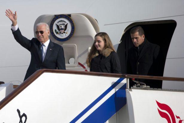 Vice President Joe Biden waves as he walks out of Air Force Two with his granddaughter Finnegan Biden (C) and son Hunter Biden (R) at the airport in Beijing, China on Dec. 4, 2013. (Photo by Ng Han Guan-Pool/Getty Images)