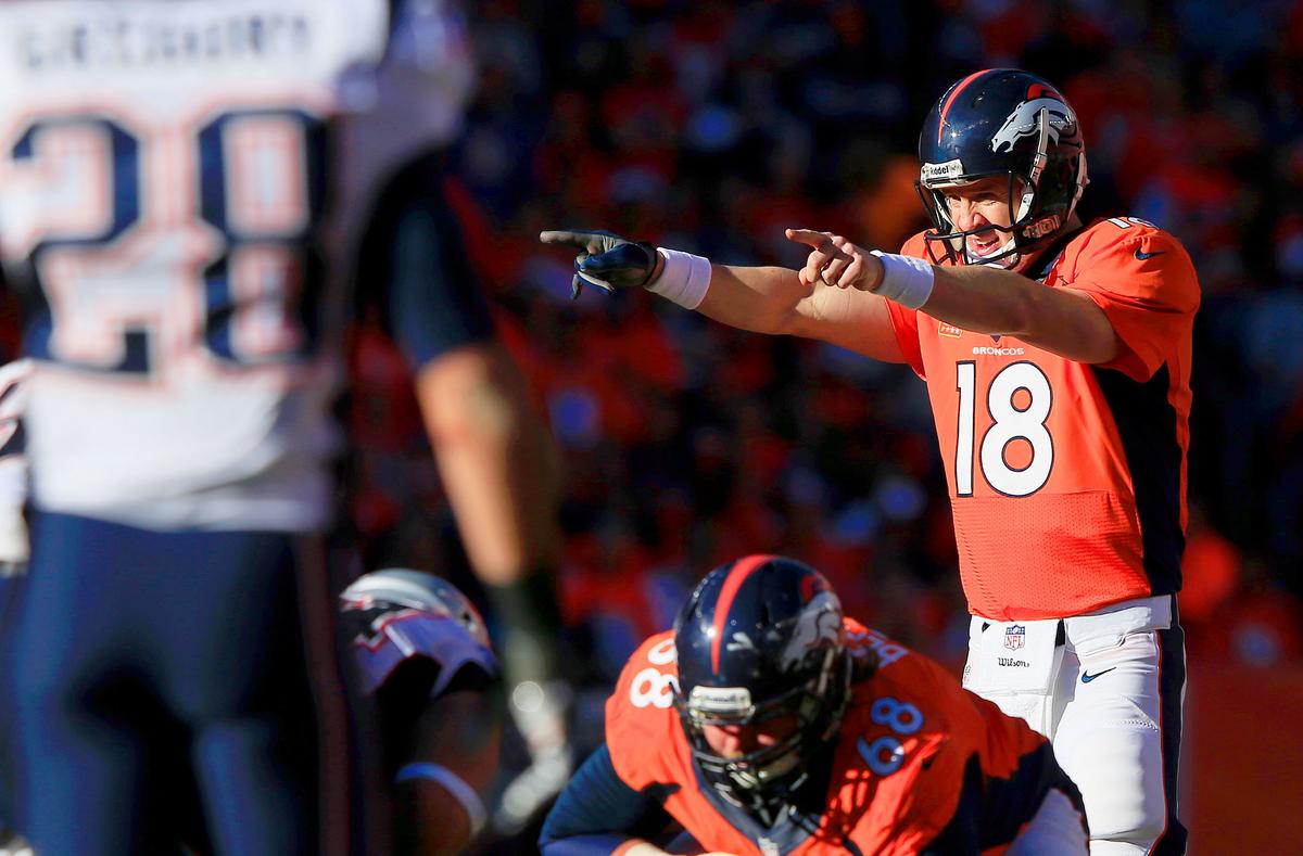Denver Broncos quarterback #18 Peyton Manning redesigns his blocking protection before calling for the snap in the third quarter of the Denver Broncos/t the New England Patriots AFC Championship game at Sports Authority Field at Mile High in Denver, Colorado on January 19, 2014. (Jamie Squire/Getty Images)